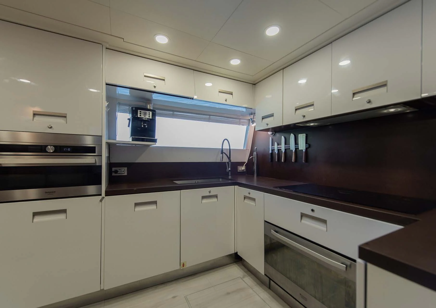 a kitchen with white cabinets aboard DALOLI Yacht for Charter