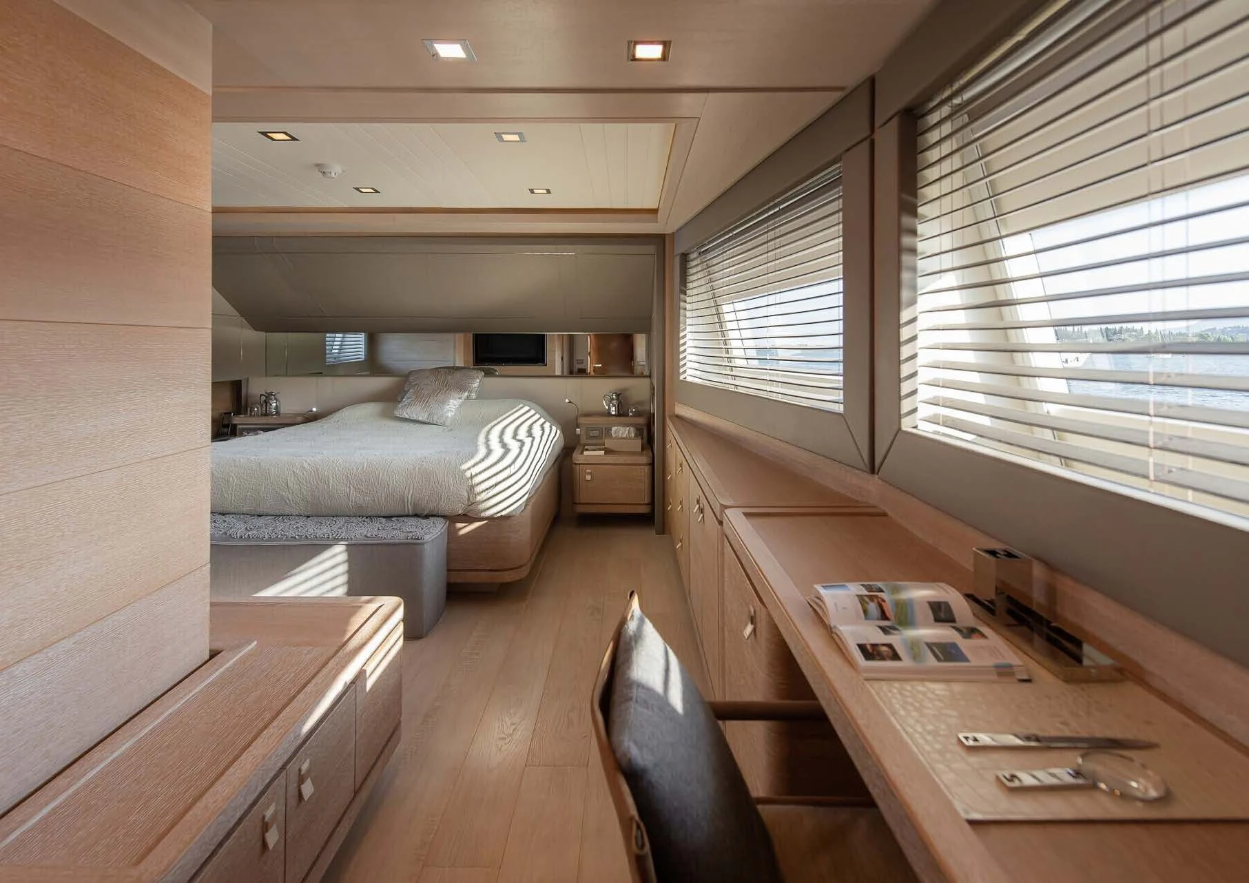 a room with a bed and desk aboard DALOLI Yacht for Charter