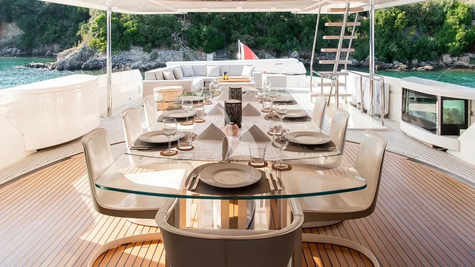 a table set for a dinner party aboard DALOLI Yacht for Charter