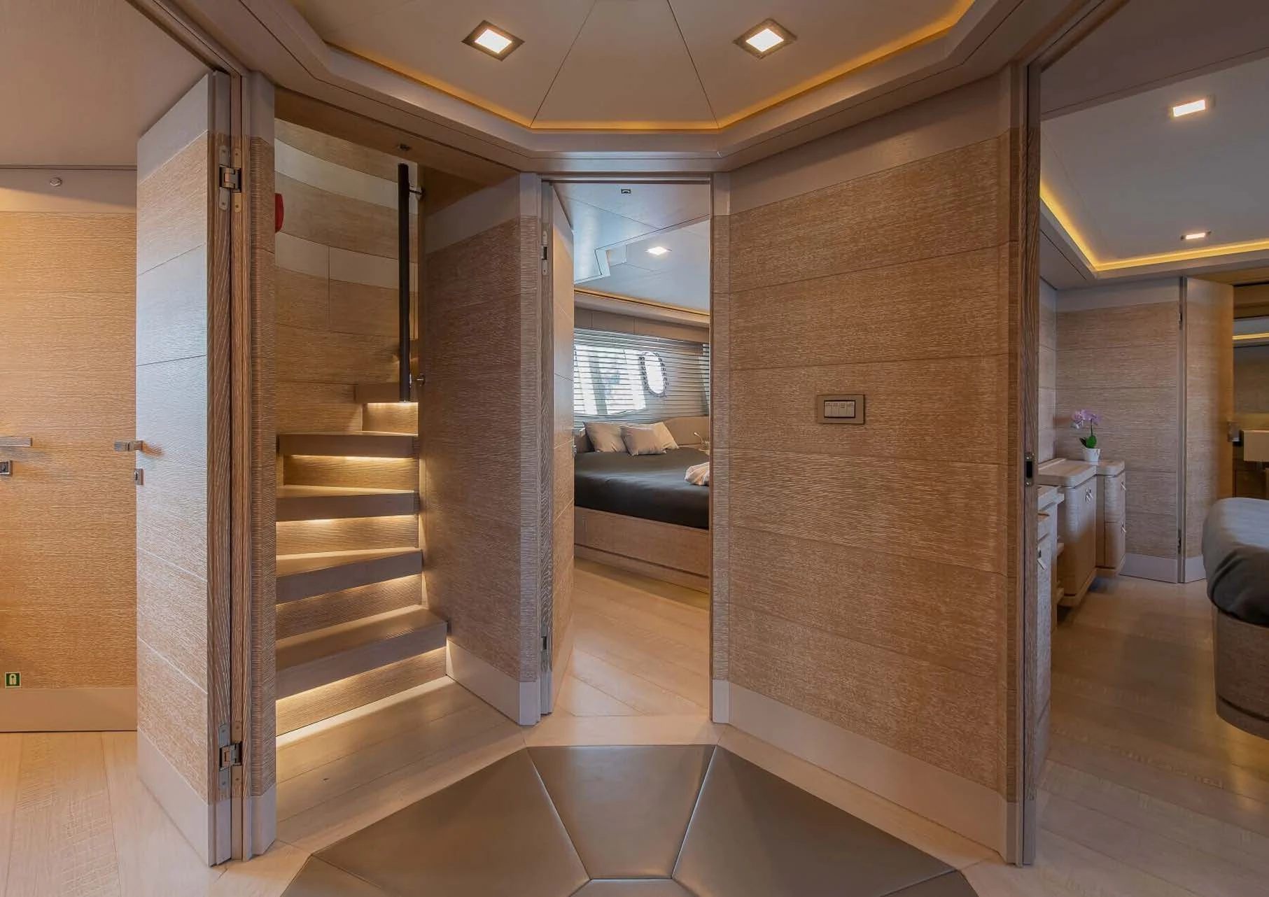a room with a staircase and a couch aboard DALOLI Yacht for Charter