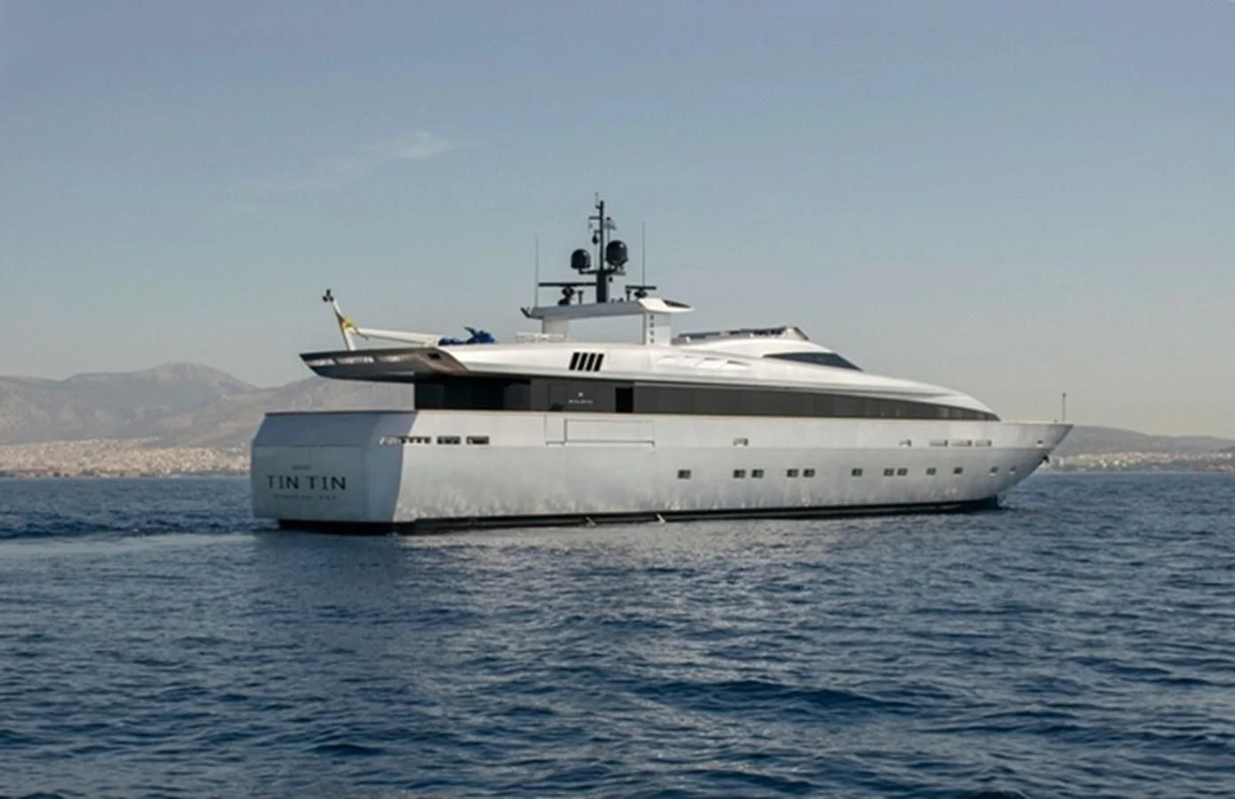 a large white ship in the water aboard TIN TIN Yacht for Sale