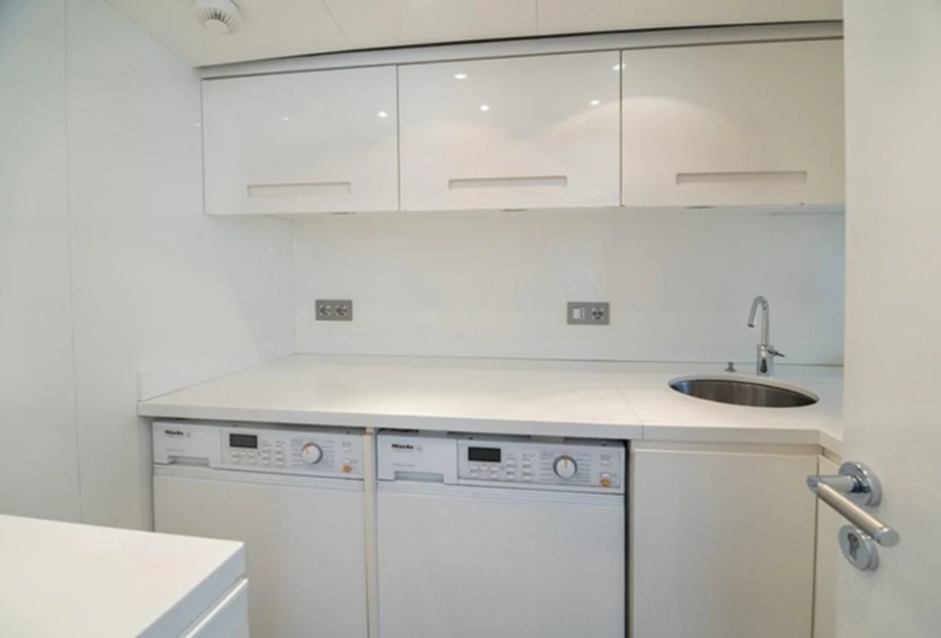 a kitchen with white appliances aboard TIN TIN Yacht for Sale