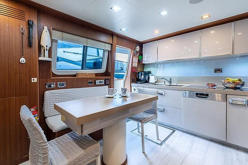 a kitchen with a table and chairs aboard BLUE LINE Yacht for Sale