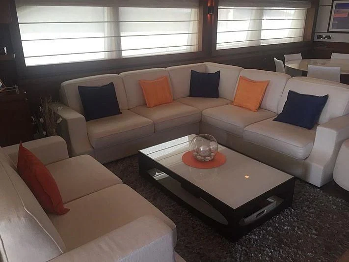 a living room with a couch and coffee table aboard BLUE LINE Yacht for Sale