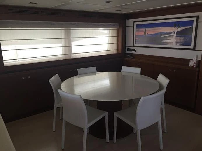 a table and chairs in a room aboard BLUE LINE Yacht for Sale