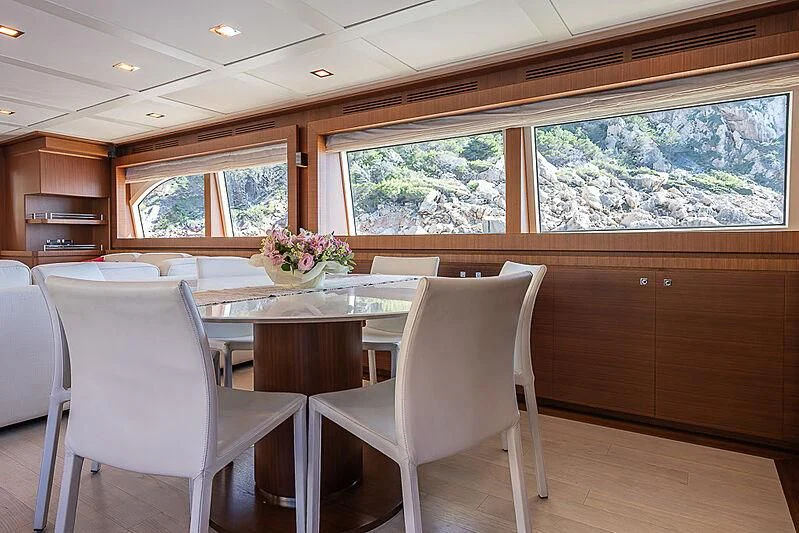 a room with a table and chairs aboard BLUE LINE Yacht for Sale
