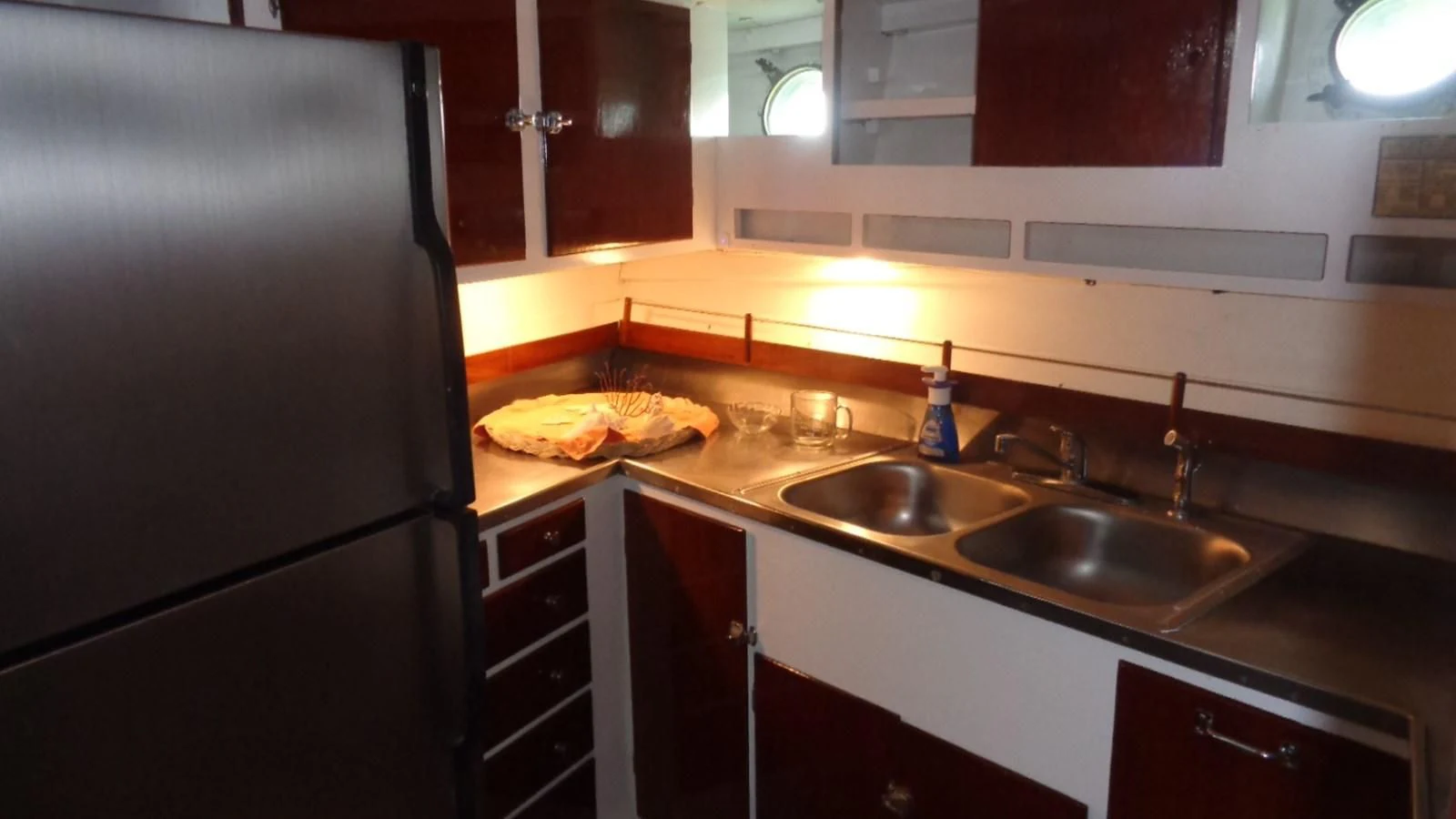 a kitchen with a stainless steel refrigerator aboard LION'S WHELP Yacht for Sale