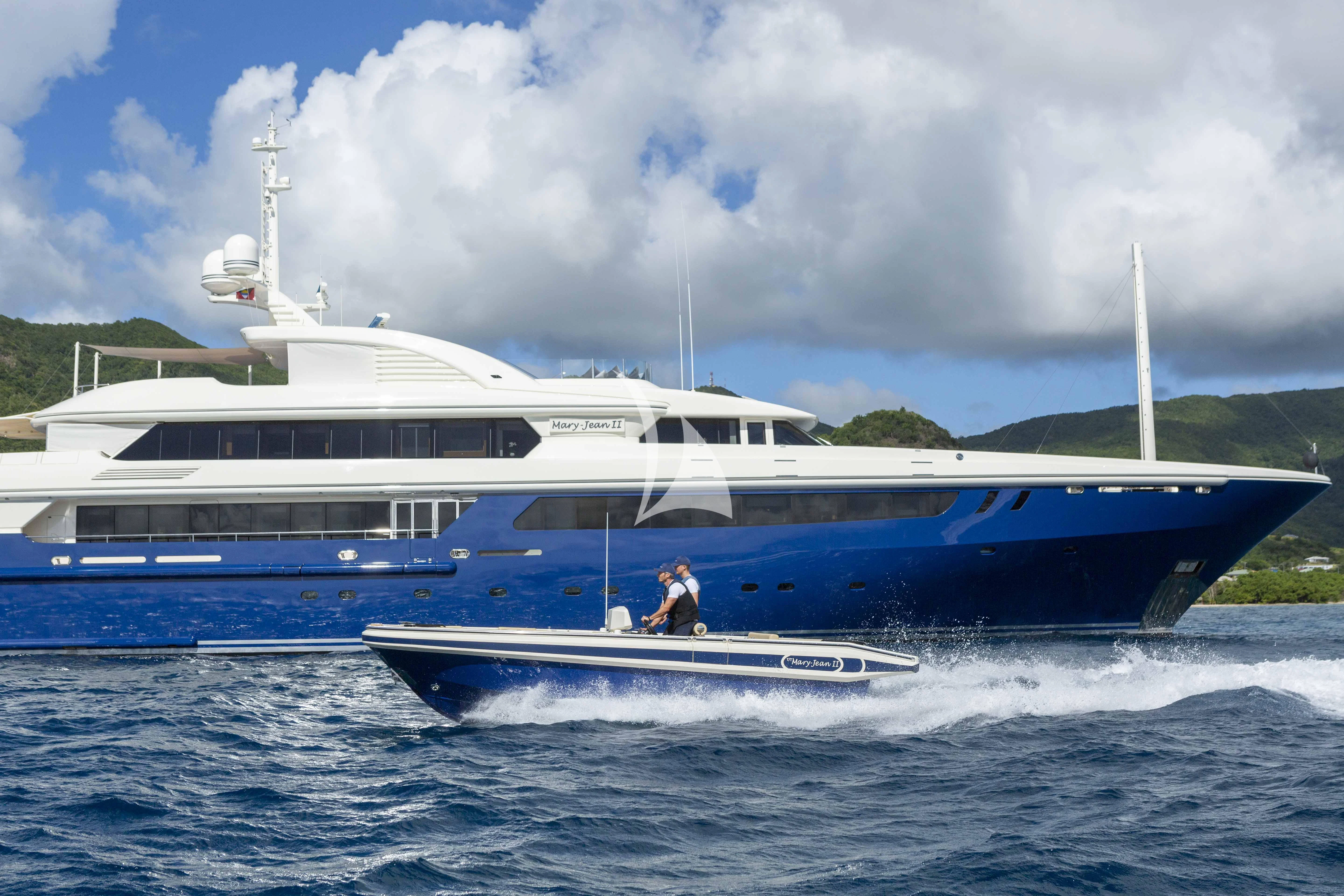 a large white boat with a person on it aboard MARY-JEAN II Yacht for Sale