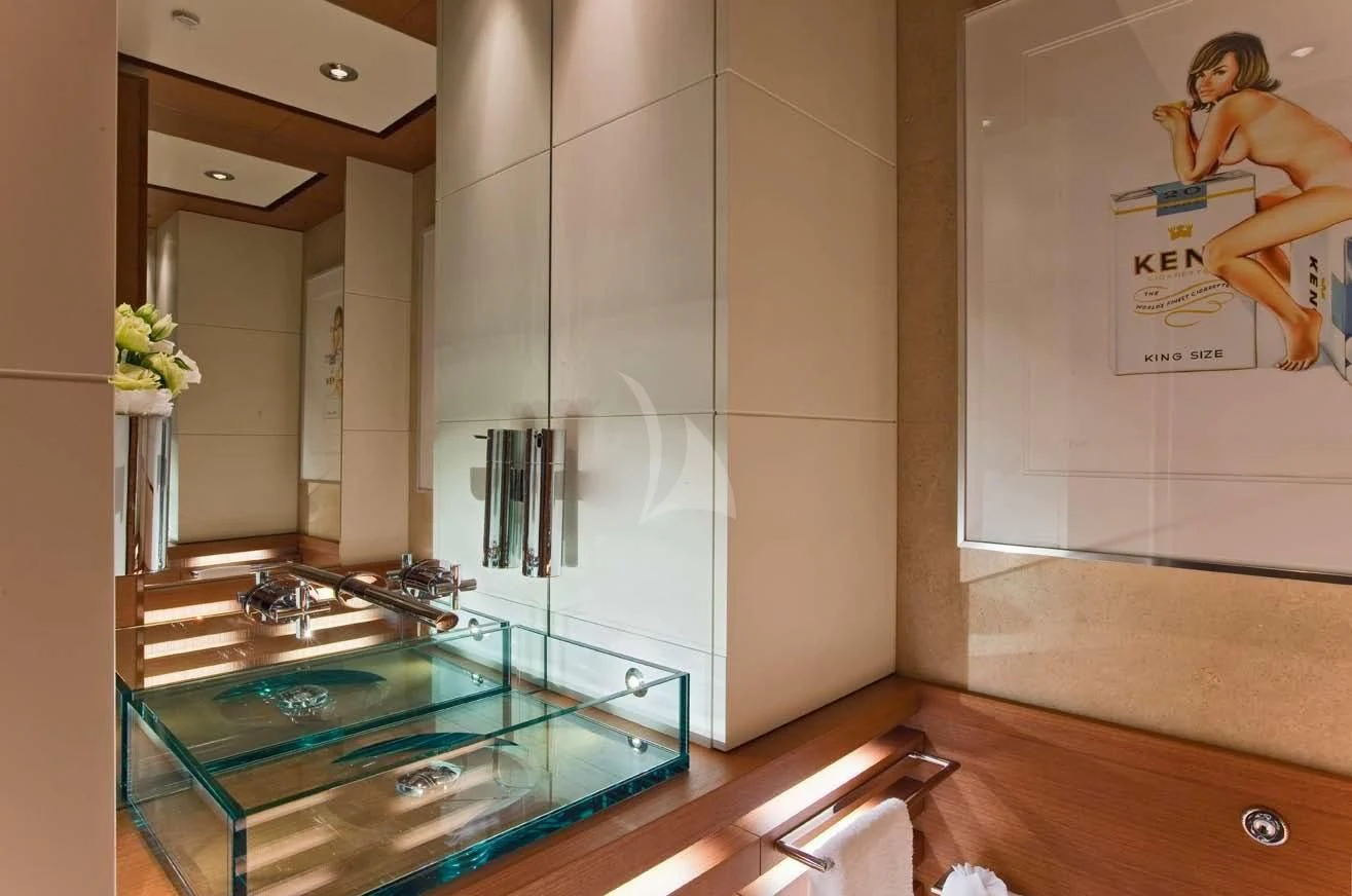 a modern kitchen with glass counter tops aboard MARY-JEAN II Yacht for Sale