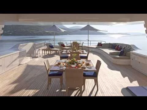 a deck with a table and chairs on it aboard MARY-JEAN II Yacht for Sale