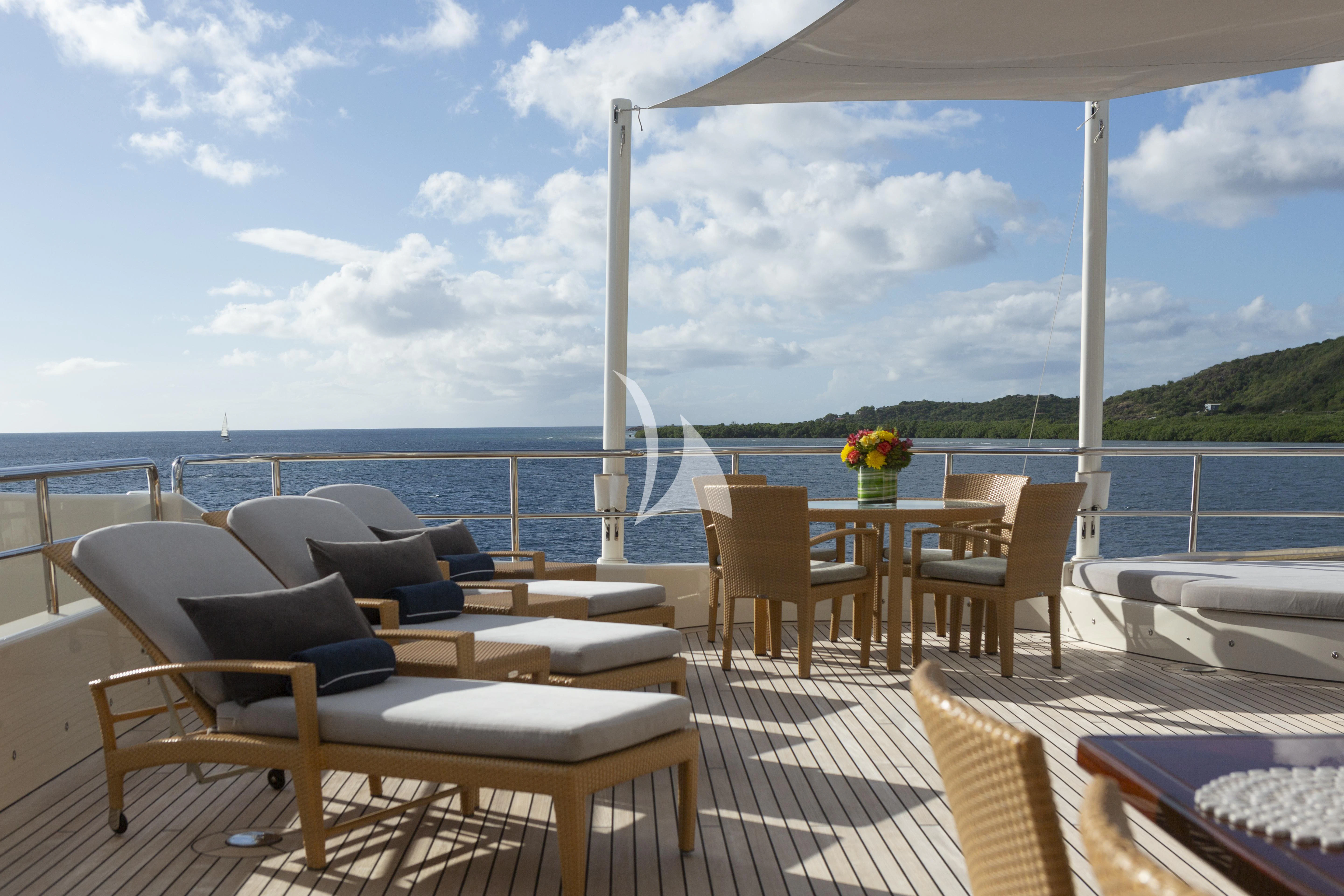 a deck with chairs and tables on it aboard MARY-JEAN II Yacht for Sale