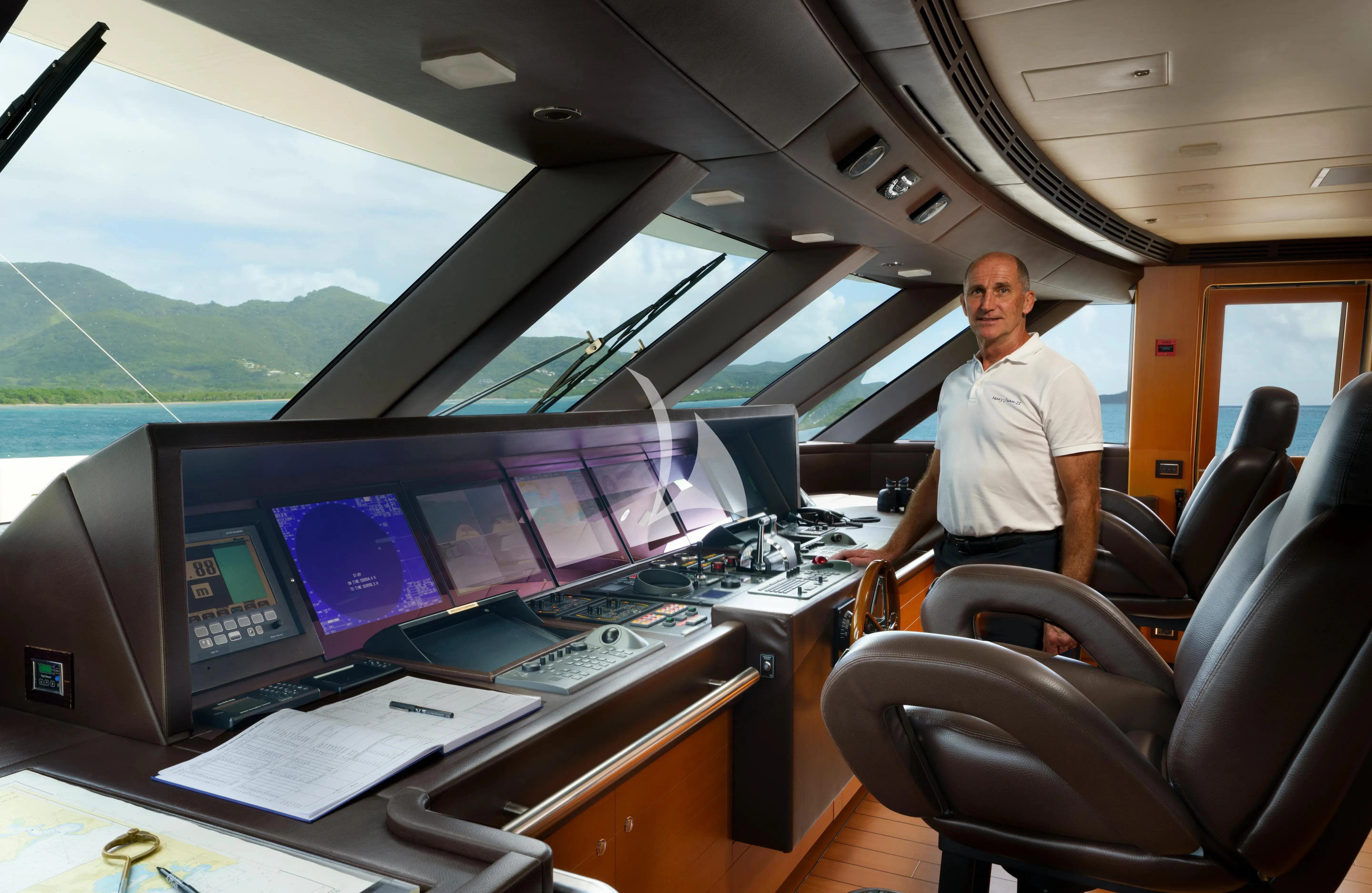 a person sitting at a desk with computers aboard MARY-JEAN II Yacht for Sale