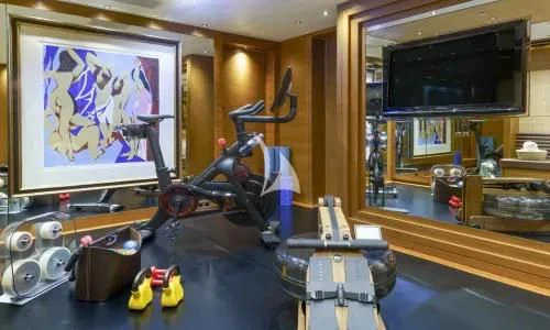 a room with a large screen and guitars on the wall aboard MARY-JEAN II Yacht for Sale