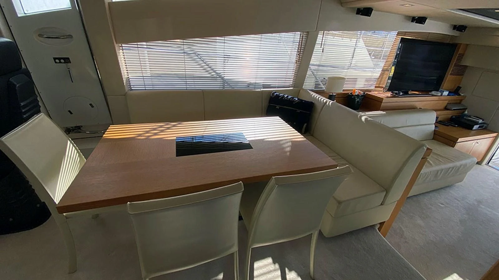 a room with a couch and a table aboard LIO Yacht for Sale