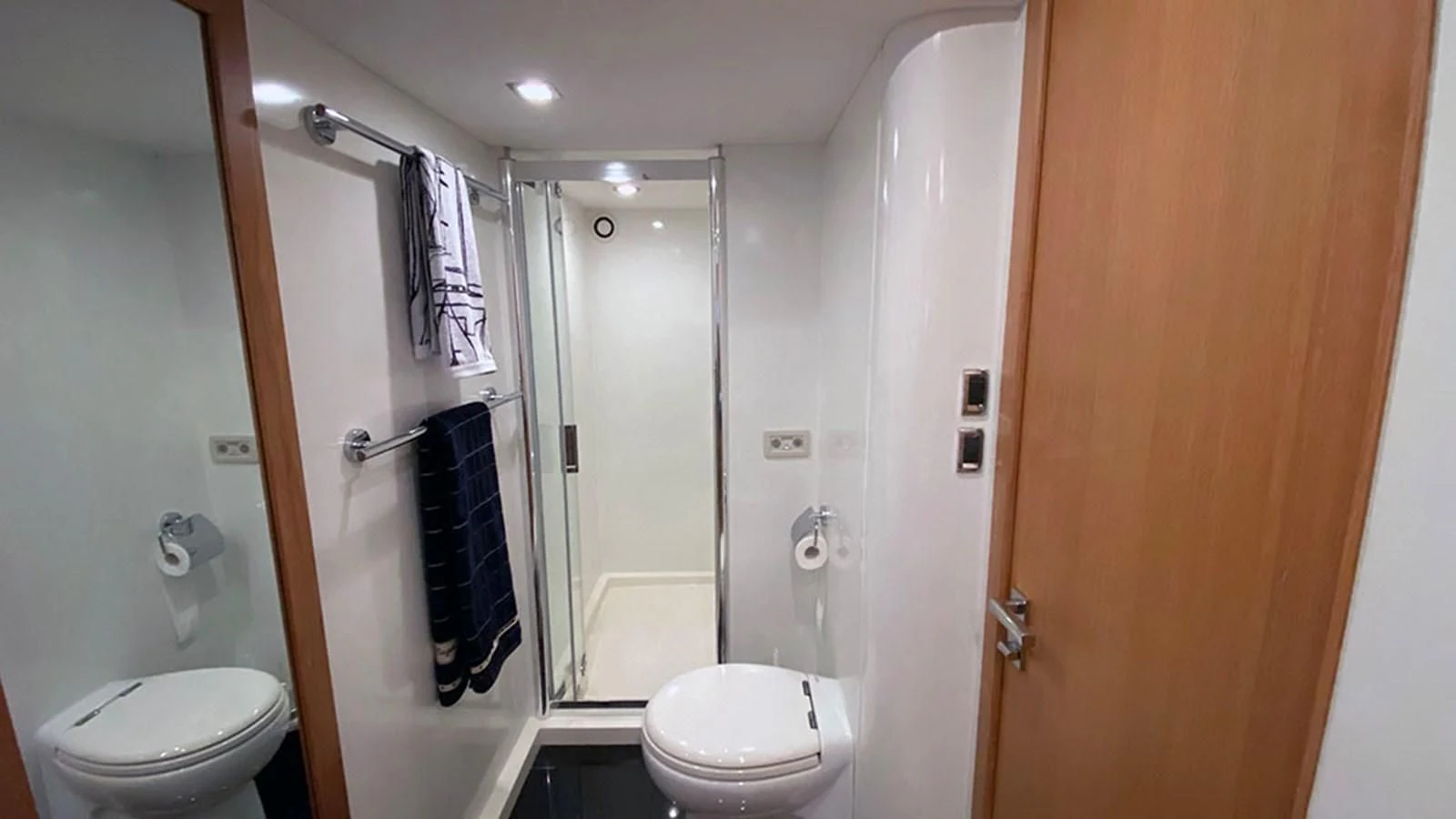 a bathroom with a glass shower door aboard LIO Yacht for Sale