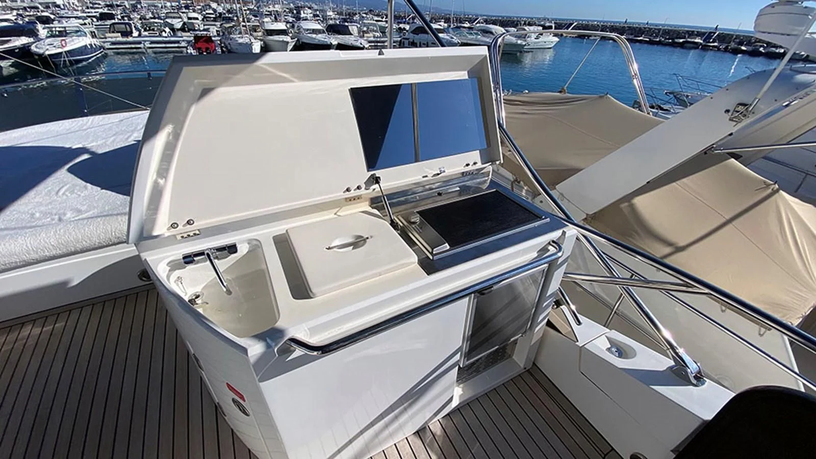 a white boat in a harbor aboard LIO Yacht for Sale