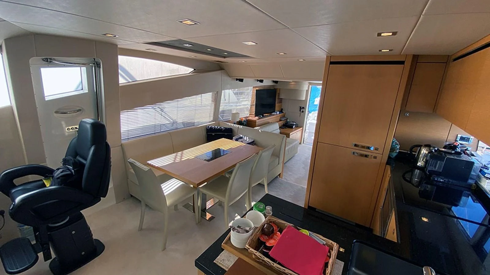 a room with a table chairs and a window aboard LIO Yacht for Sale