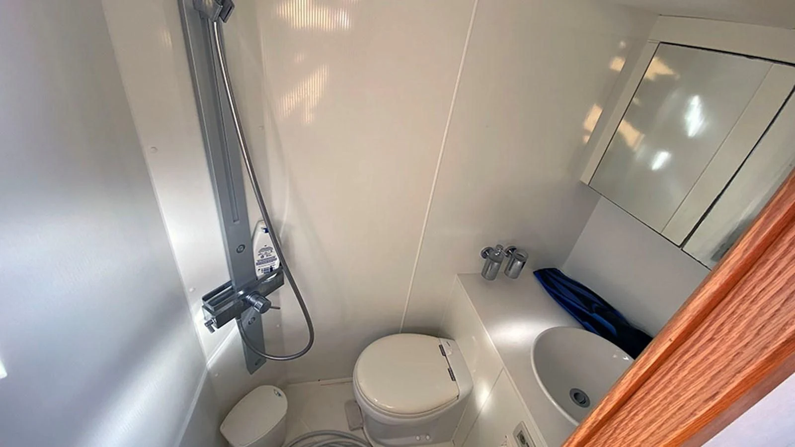 a bathroom with a toilet and a sink aboard LIO Yacht for Sale