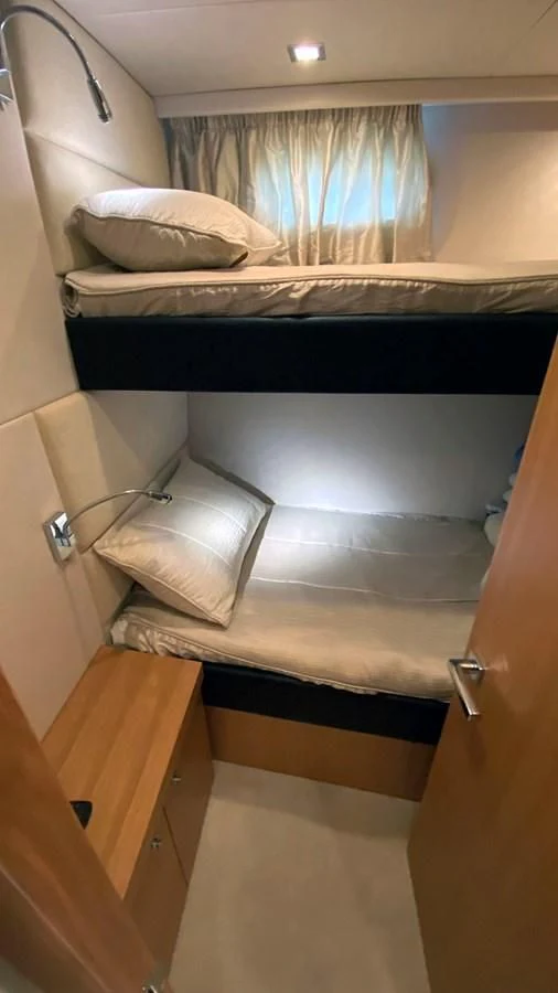 a bed with white sheets aboard LIO Yacht for Sale