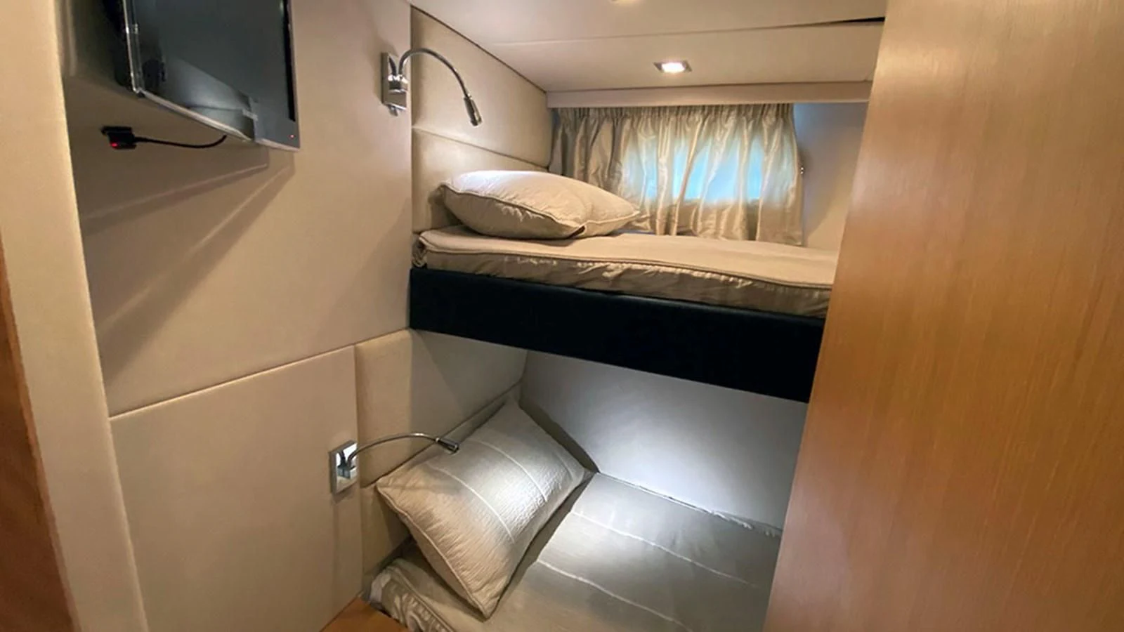 a room with a bed and a mirror aboard LIO Yacht for Sale