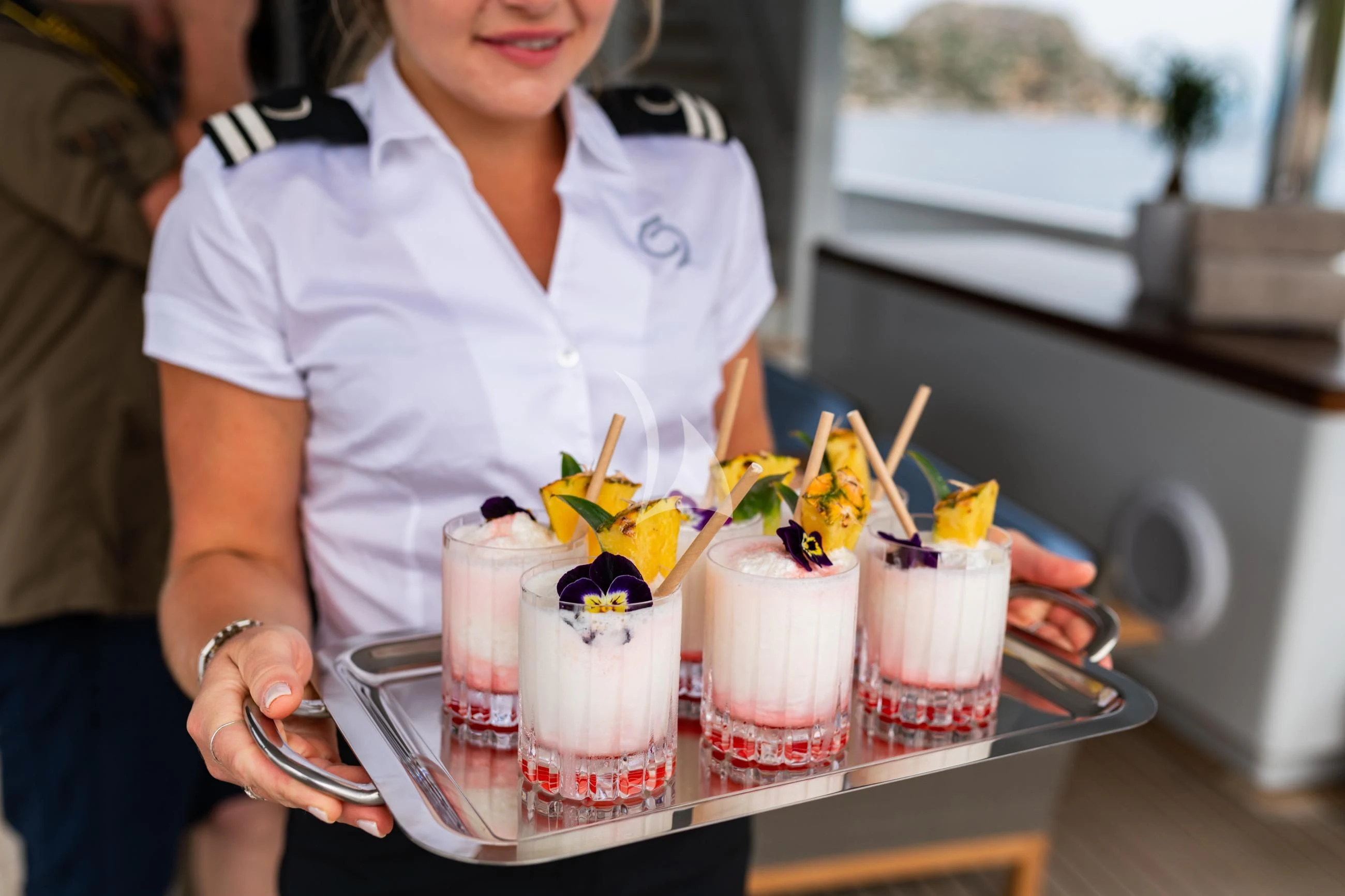 a person sitting at a table with a tray of food and drinks aboard HOLDIN' MY OWN Yacht for Sale