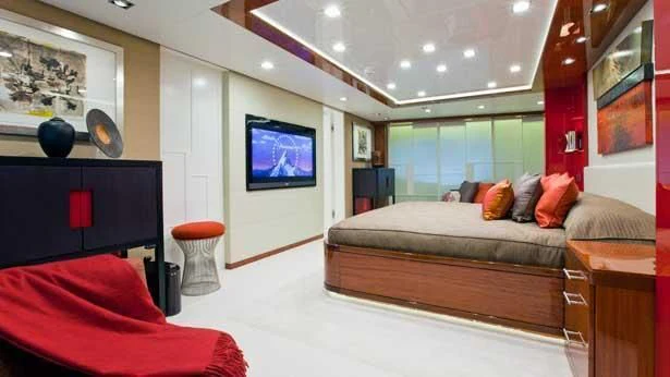 a bedroom with a bed and a tv aboard HOLDIN' MY OWN Yacht for Sale