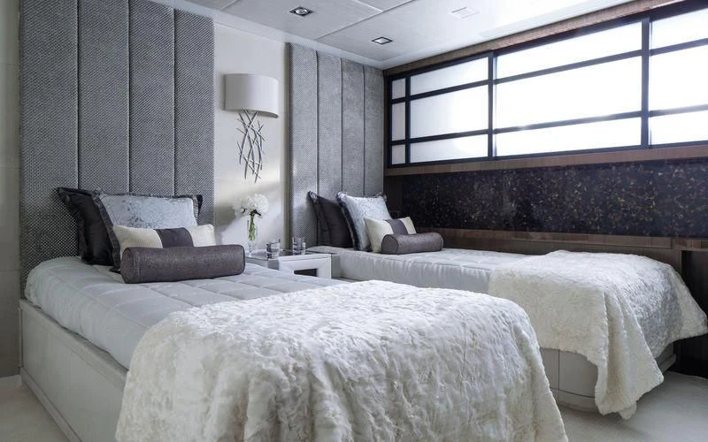 a room with a bed and a chair aboard HOLDIN' MY OWN Yacht for Sale