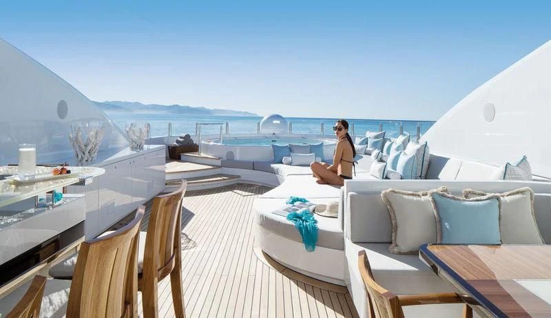 a person sitting on a deck of a boat aboard HOLDIN' MY OWN Yacht for Sale