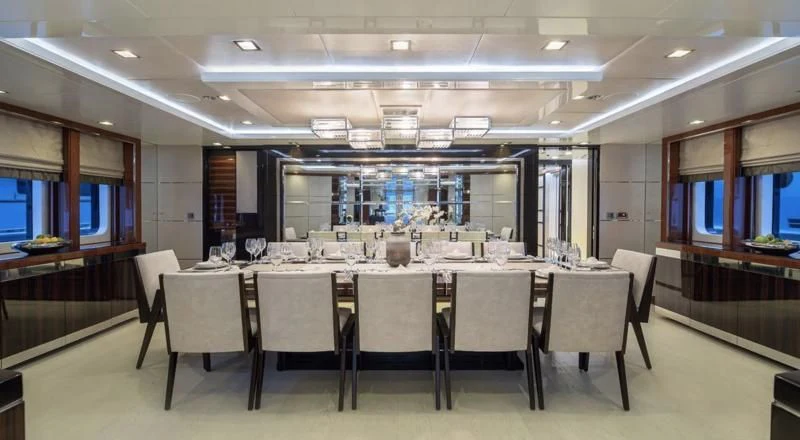 a large room with a table and chairs aboard HOLDIN' MY OWN Yacht for Sale