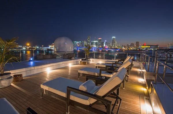 a deck with a view of a city at night aboard HOLDIN' MY OWN Yacht for Sale