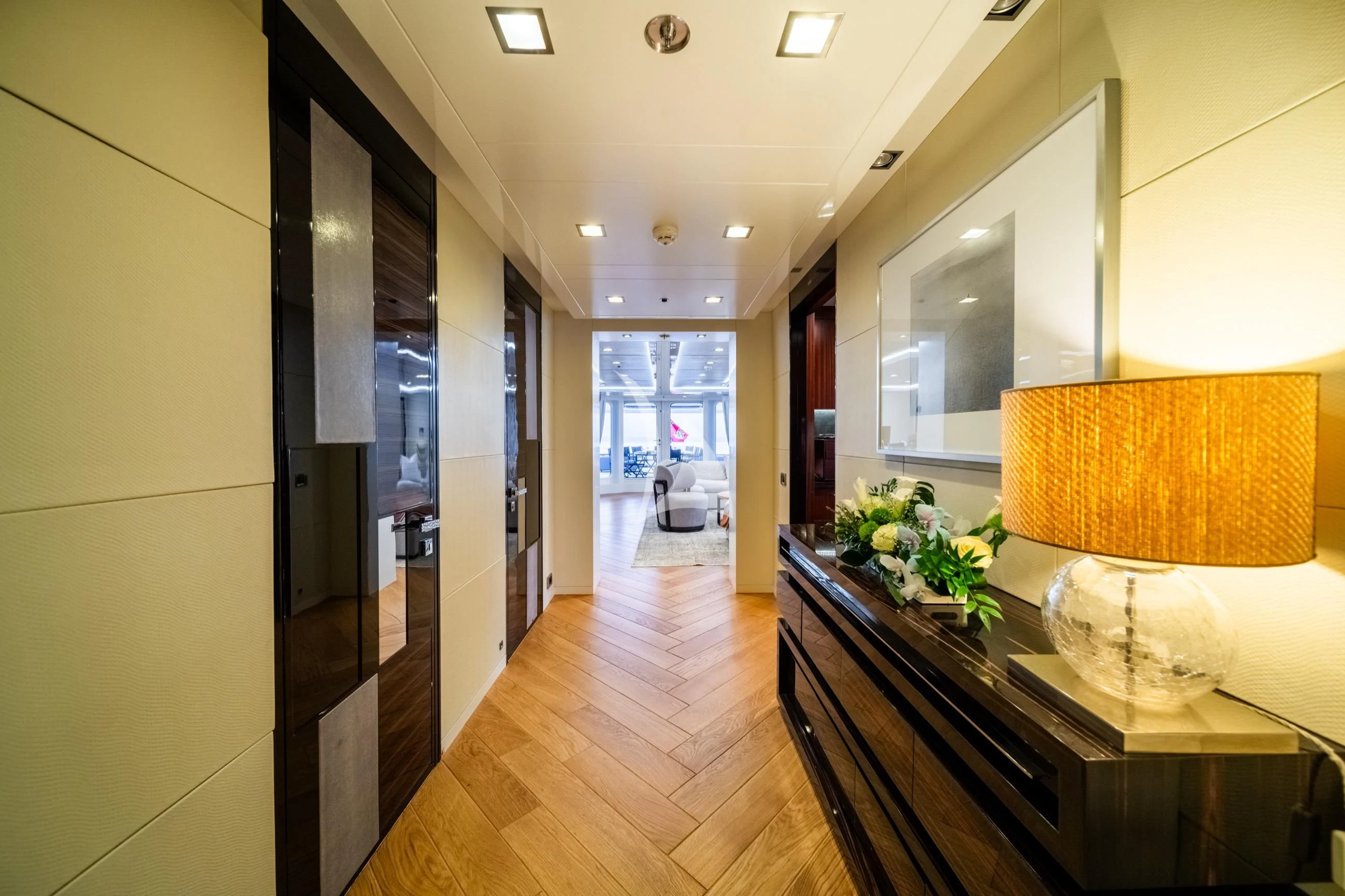 a room with a wood floor and a counter with a vase of flowers on it aboard HOLDIN' MY OWN Yacht for Sale