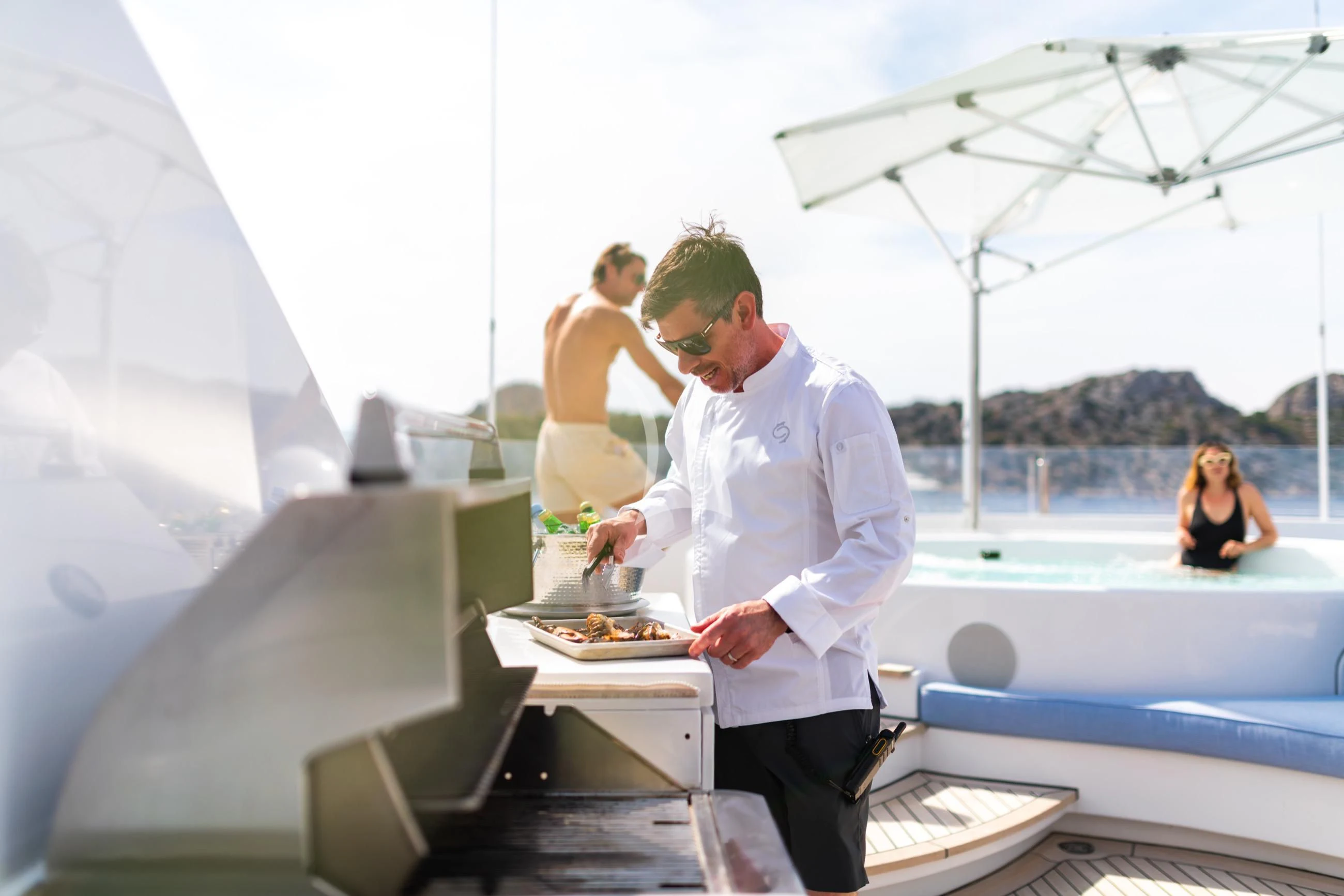 a man serving food to a woman aboard HOLDIN' MY OWN Yacht for Sale