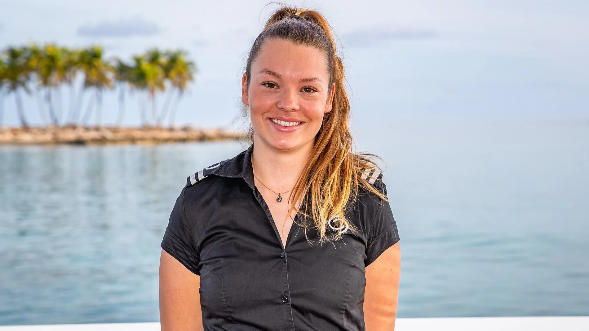 a woman smiling in front of a body of water aboard HOLDIN' MY OWN Yacht for Sale