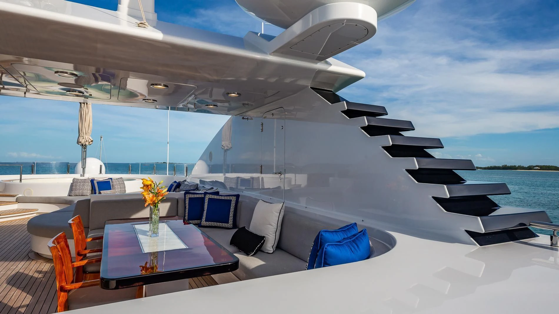 a large white yacht with a table and chairs on a deck aboard HOLDIN' MY OWN Yacht for Sale
