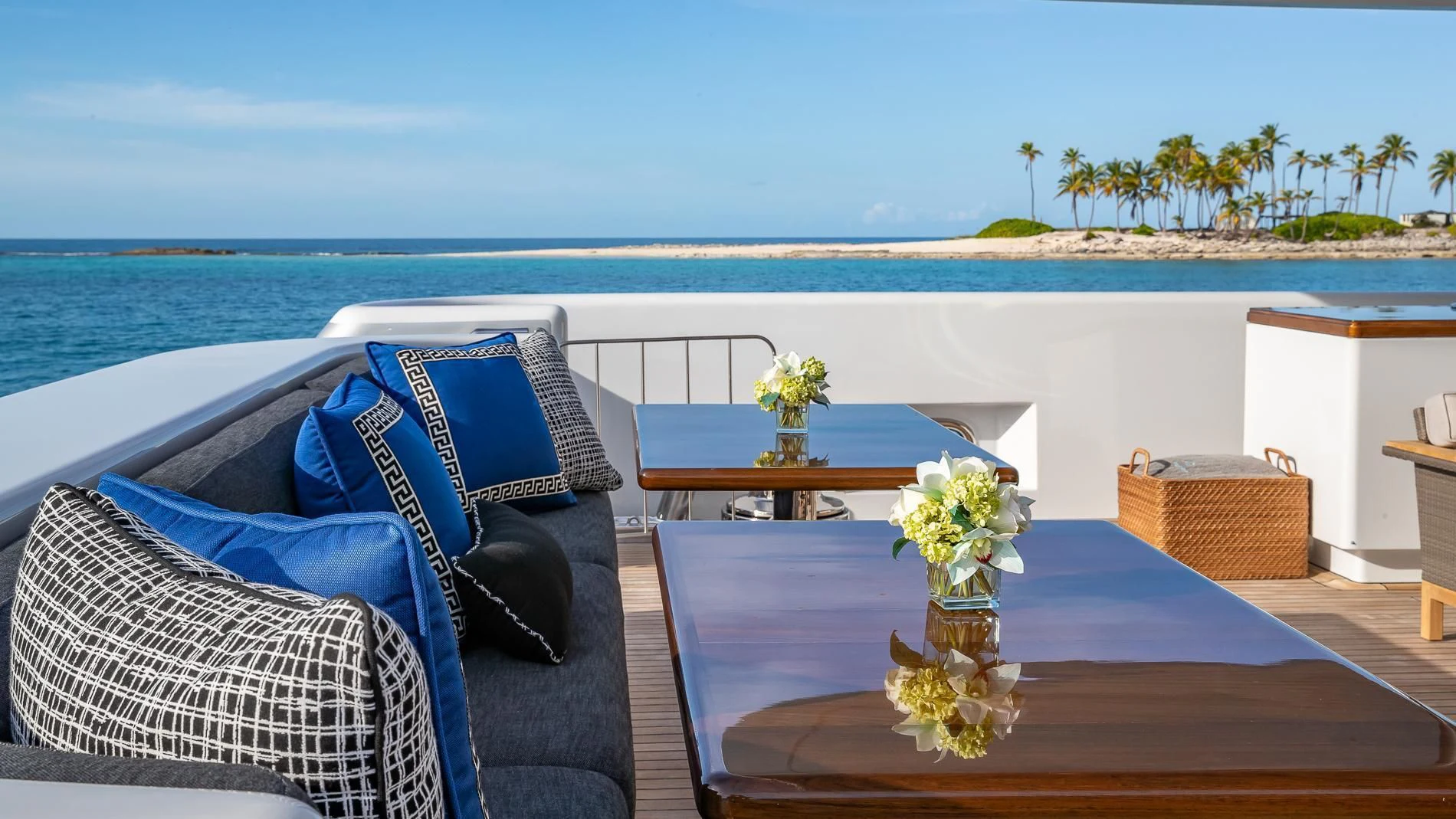 a table and chairs on a balcony overlooking a beach aboard HOLDIN' MY OWN Yacht for Sale