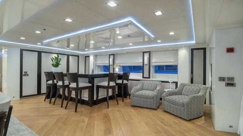 a large room with chairs and a couch aboard HOLDIN' MY OWN Yacht for Sale