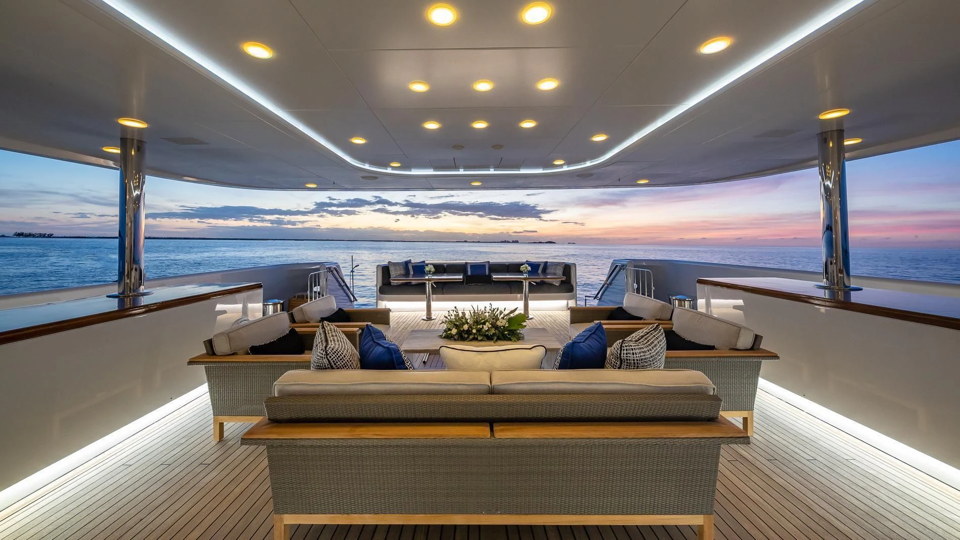 a large lounge area with a large pool and a large ship in the background aboard HOLDIN' MY OWN Yacht for Sale