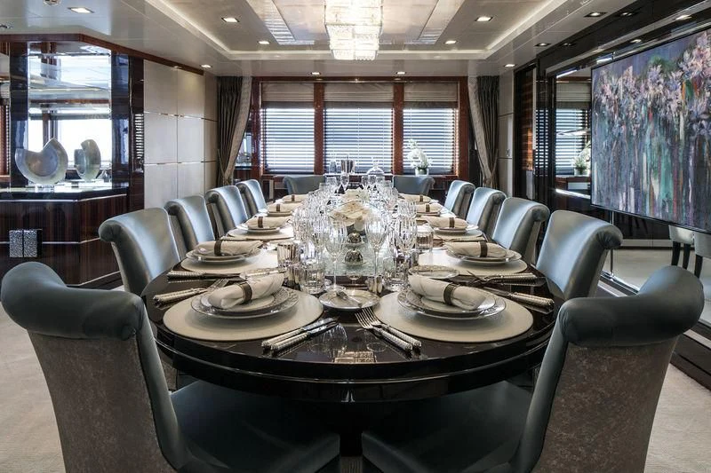 a dining room with a table set for a dinner aboard HOLDIN' MY OWN Yacht for Sale