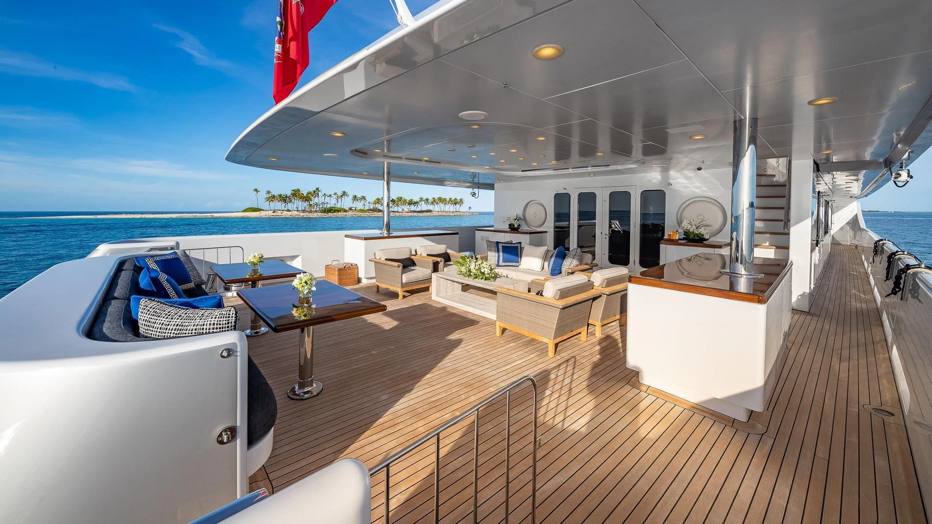 a deck with a table and chairs on it aboard HOLDIN' MY OWN Yacht for Sale