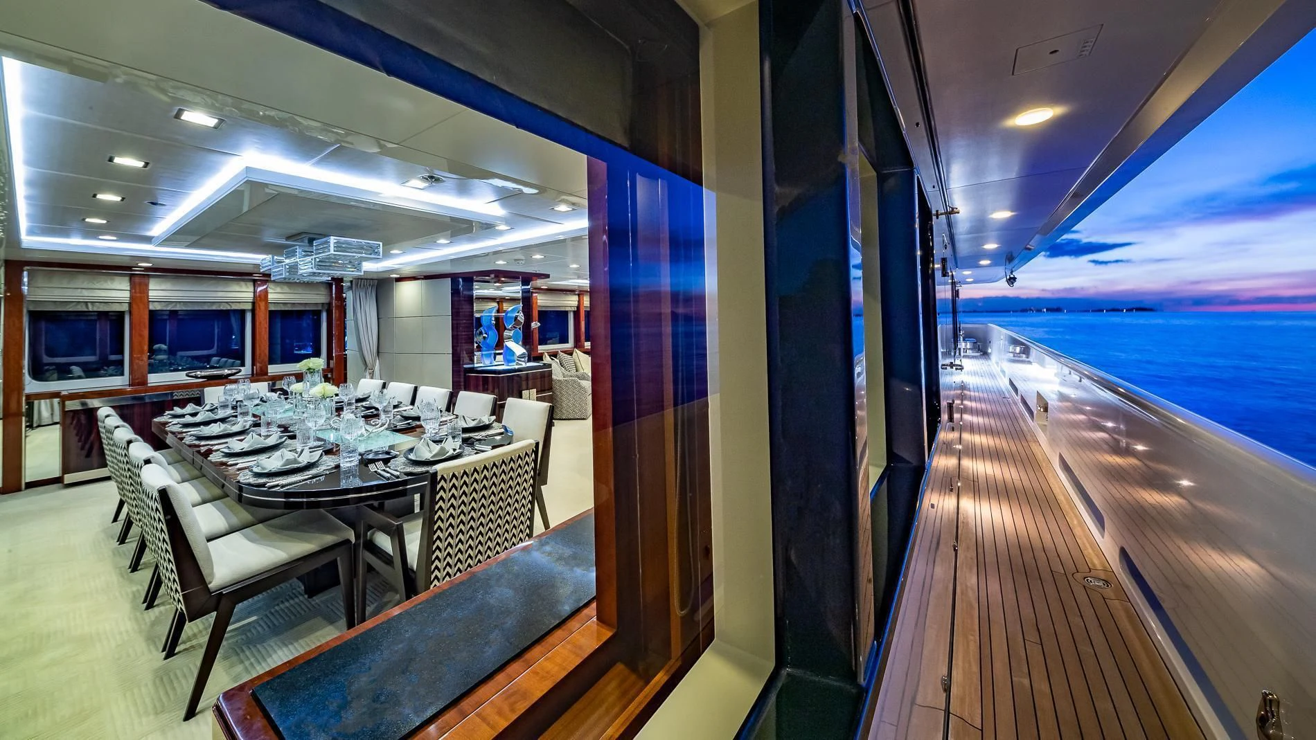 a long table with chairs and a view of the ocean aboard HOLDIN' MY OWN Yacht for Sale