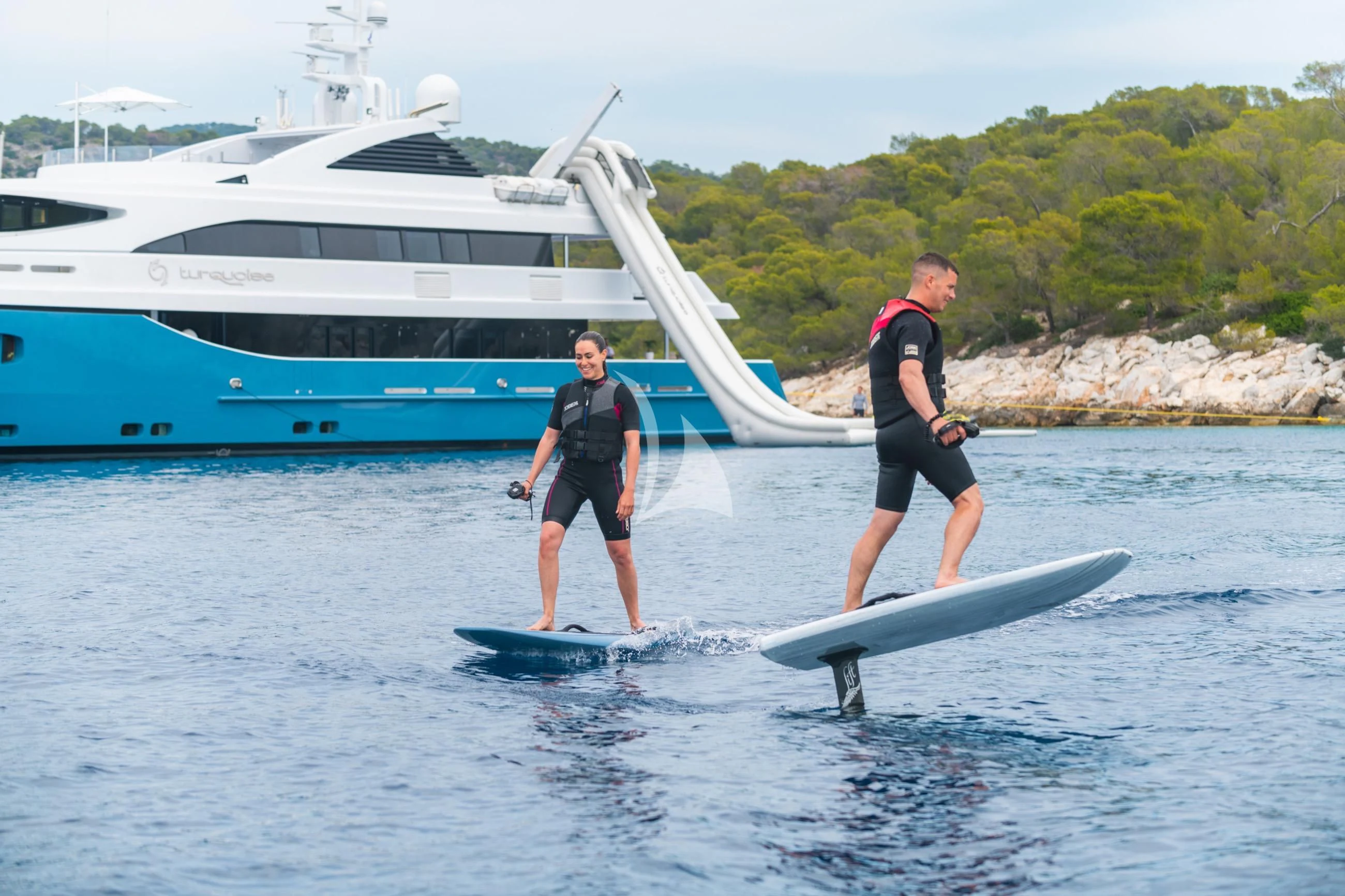 a couple of men on surfboards in the water by a boat aboard HOLDIN' MY OWN Yacht for Sale