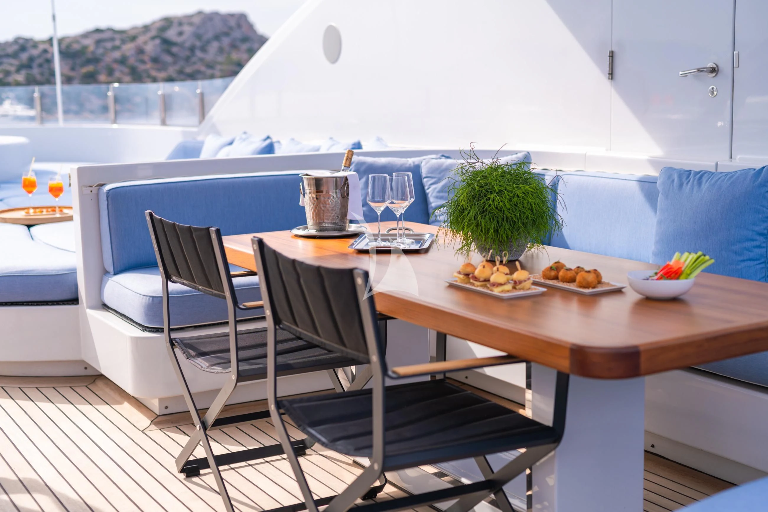 a table with a chair and a plant on it aboard HOLDIN' MY OWN Yacht for Sale