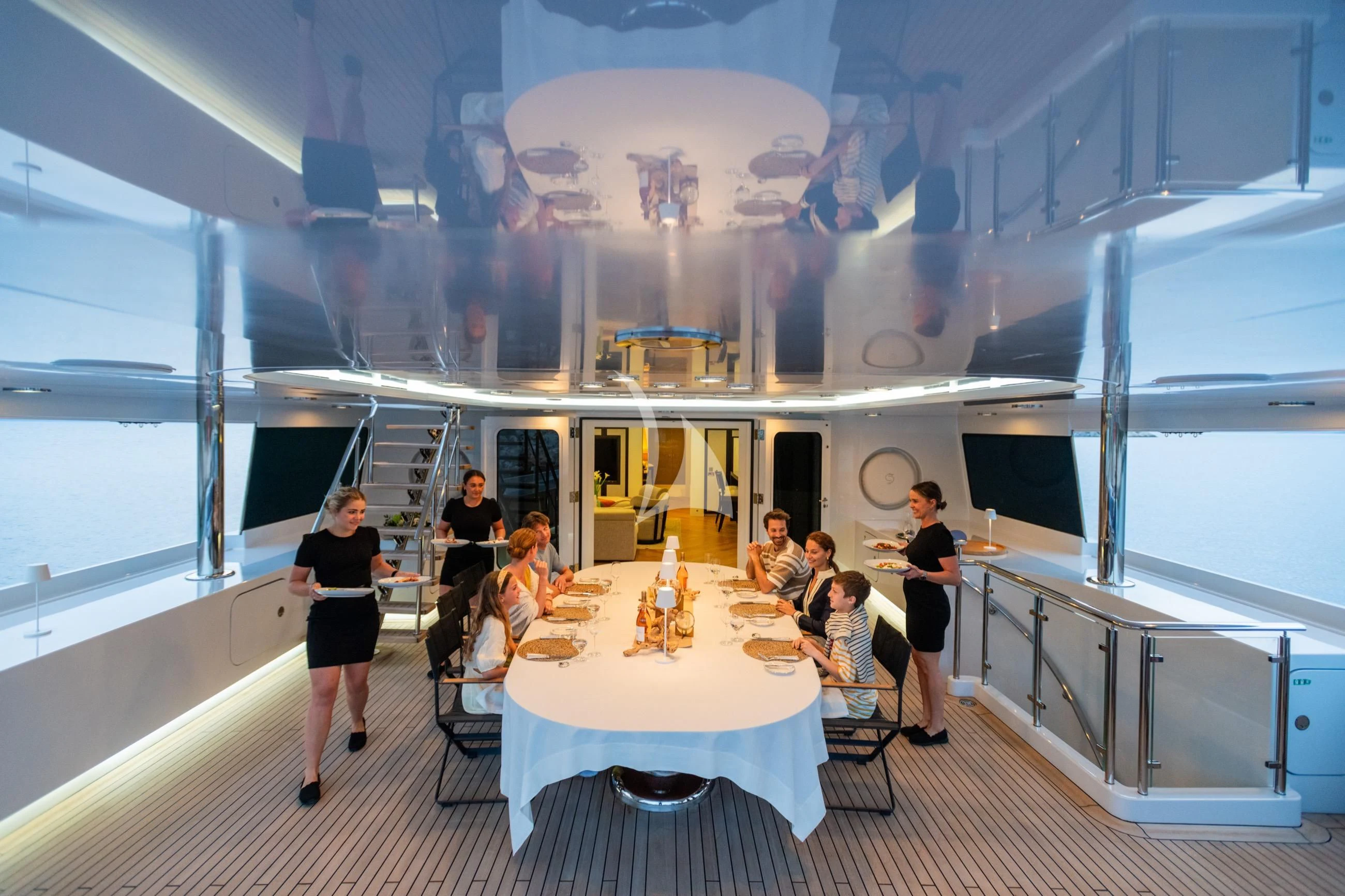a group of people sitting around a table aboard HOLDIN' MY OWN Yacht for Sale