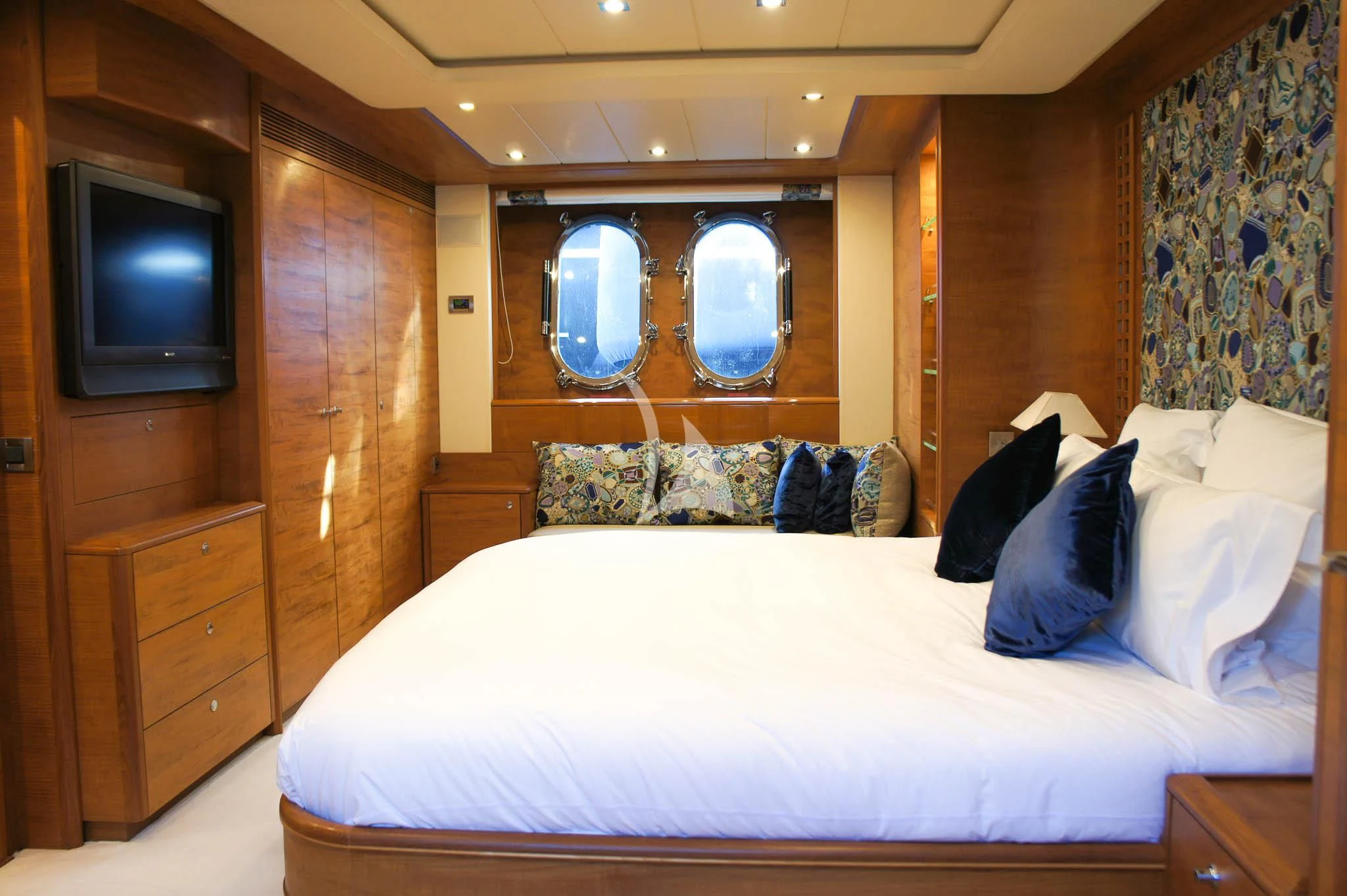 a bed with a white sheet and pillows on it aboard LADY EMMA Yacht for Sale
