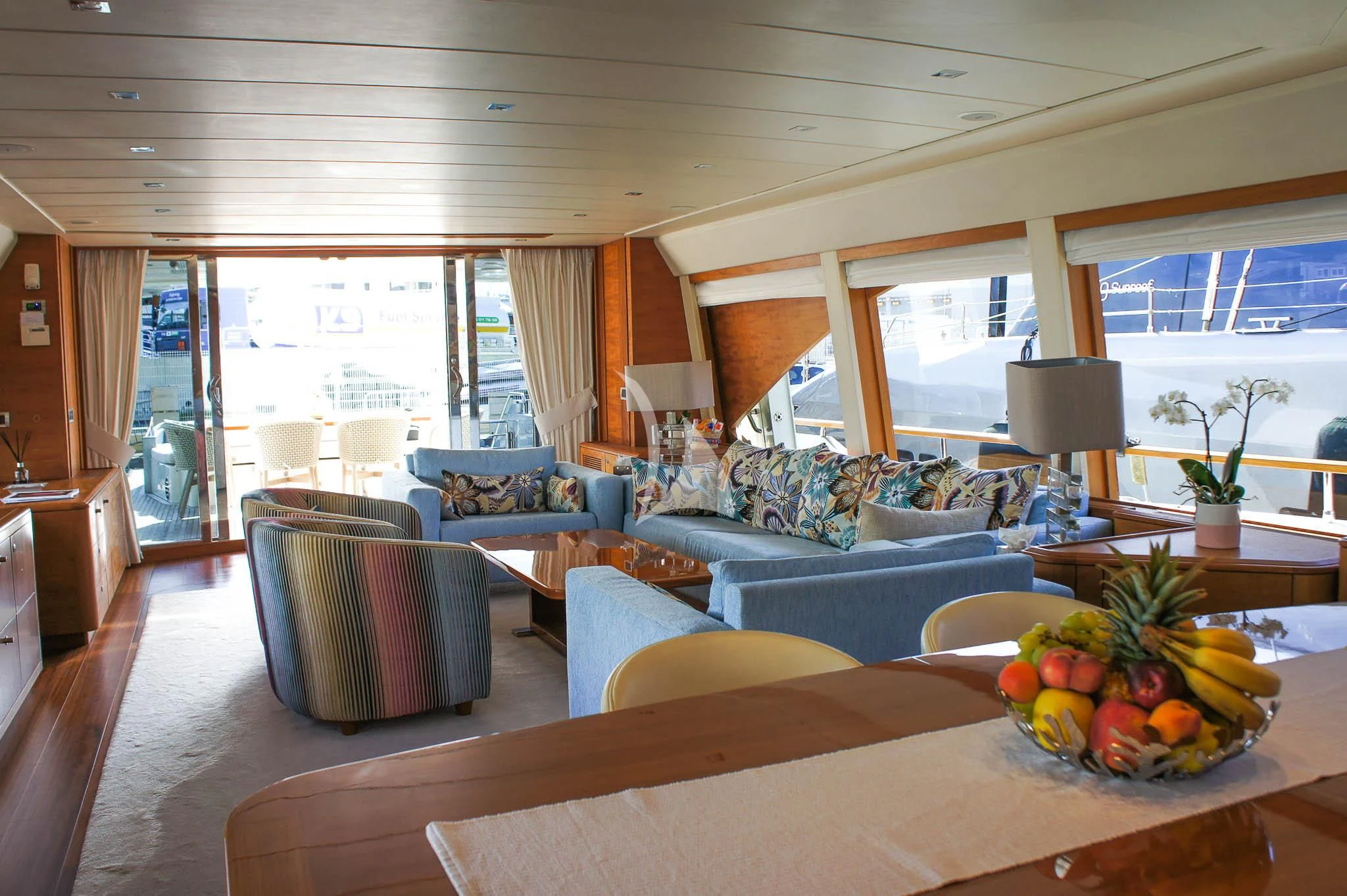 a living room with a table and couches aboard LADY EMMA Yacht for Sale