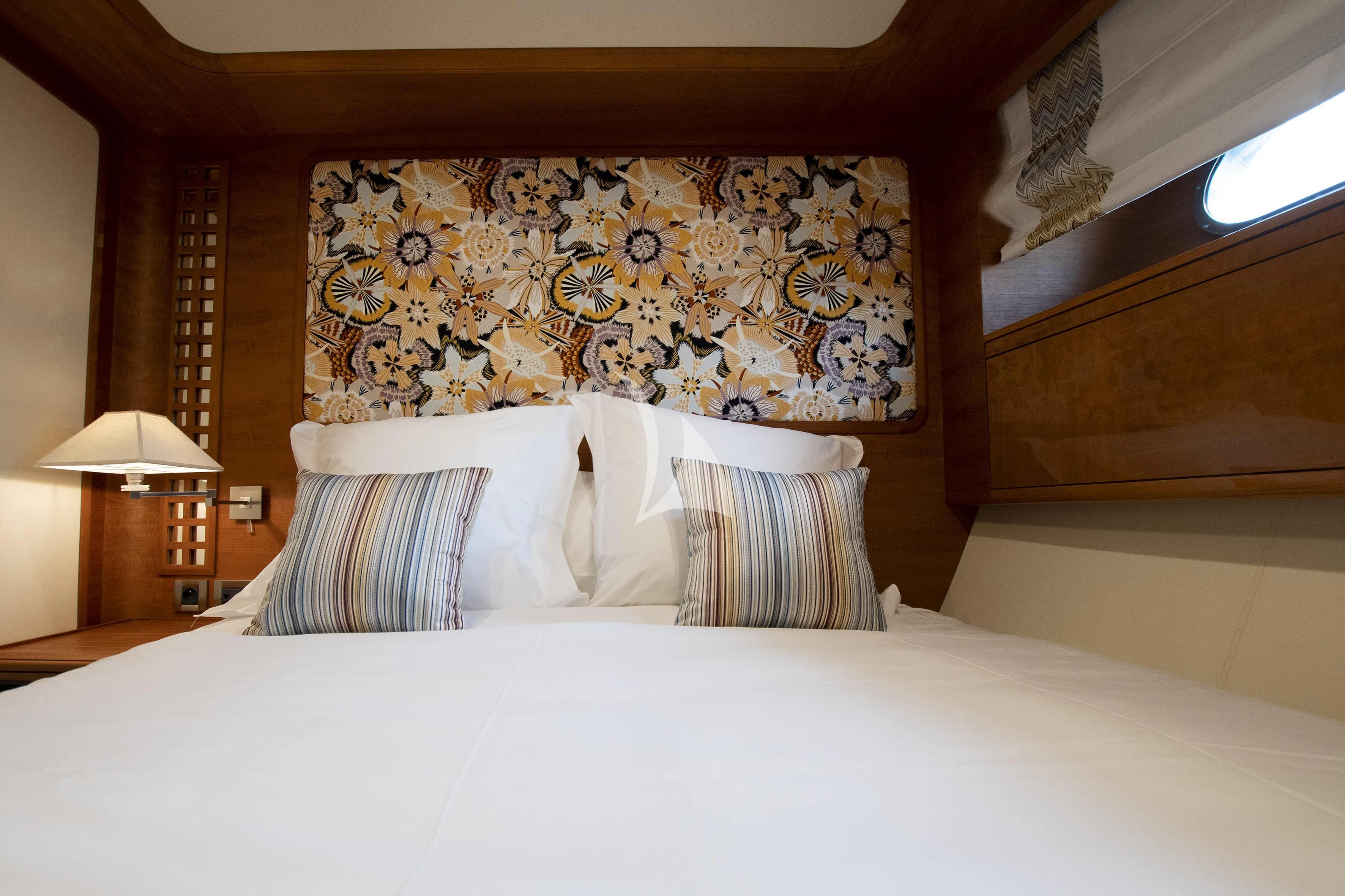 a bed with white sheets and pillows aboard LADY EMMA Yacht for Sale