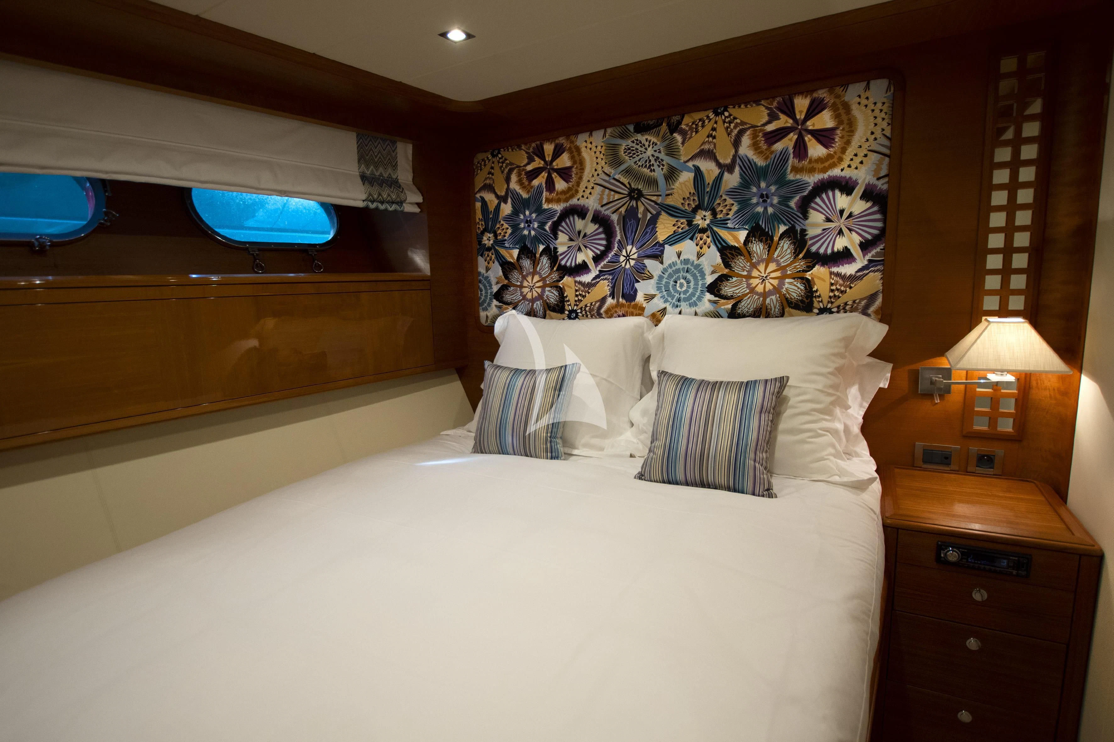 a bed with a painting on the wall aboard LADY EMMA Yacht for Sale