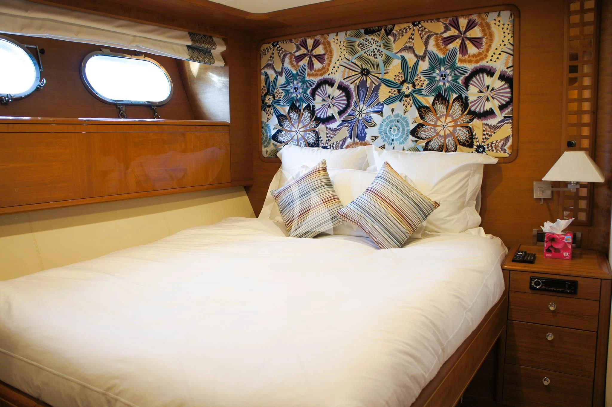 a bed with a painting on the wall aboard LADY EMMA Yacht for Sale