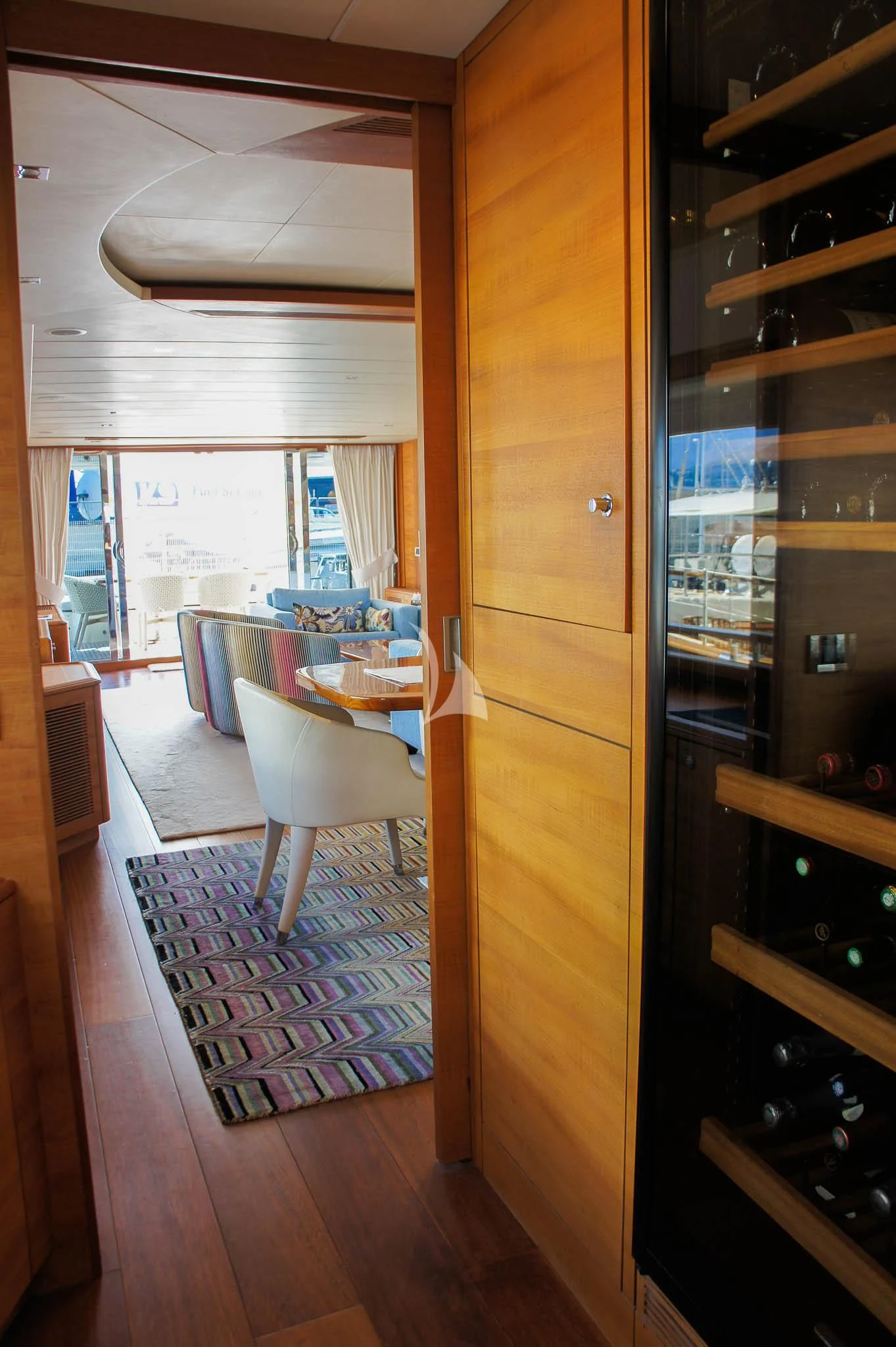 a room with a wood door and a table with chairs aboard LADY EMMA Yacht for Sale