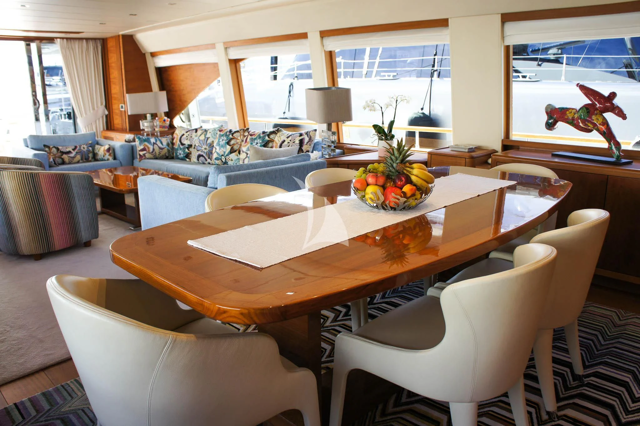 a dining table with a bowl of fruit on it aboard LADY EMMA Yacht for Sale
